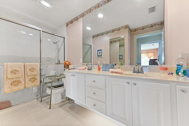 bathroom with vanity, toilet, a shower with door, and tile patterned flooring