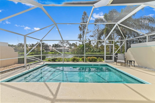 view of swimming pool with a water view, glass enclosure, and a patio area