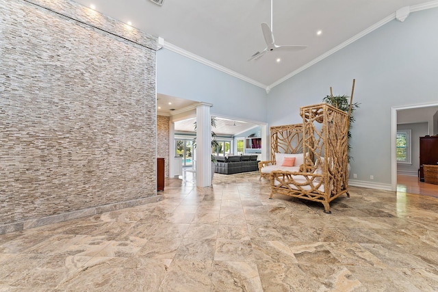 living area featuring ceiling fan, high vaulted ceiling, and ornamental molding