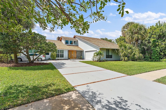 view of front of property featuring a garage and a front lawn