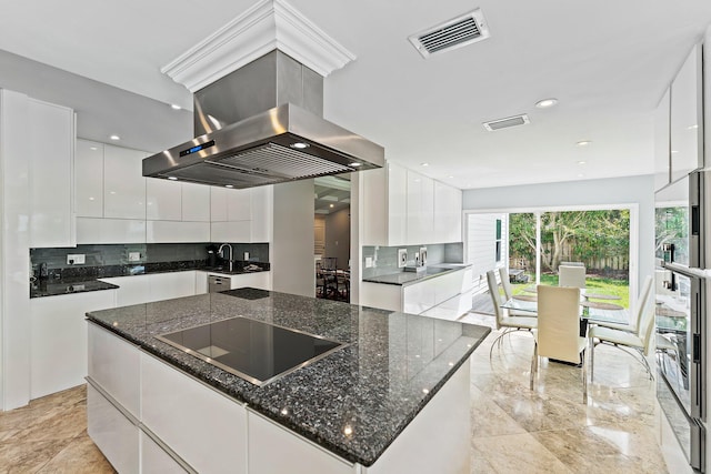 kitchen with white cabinetry, a kitchen island, island exhaust hood, black electric stovetop, and decorative backsplash