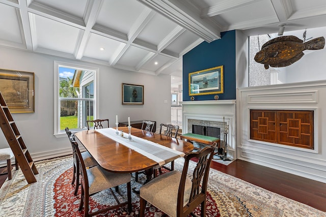 dining room featuring coffered ceiling, hardwood / wood-style floors, and vaulted ceiling with beams