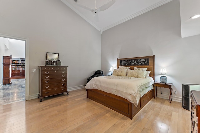 bedroom with ceiling fan, light hardwood / wood-style floors, a high ceiling, and crown molding