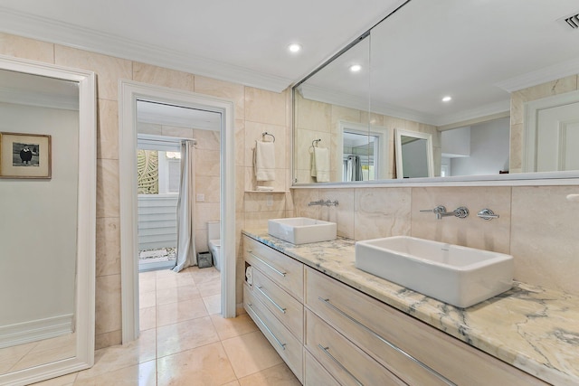 bathroom featuring toilet, tile walls, tile patterned flooring, and crown molding