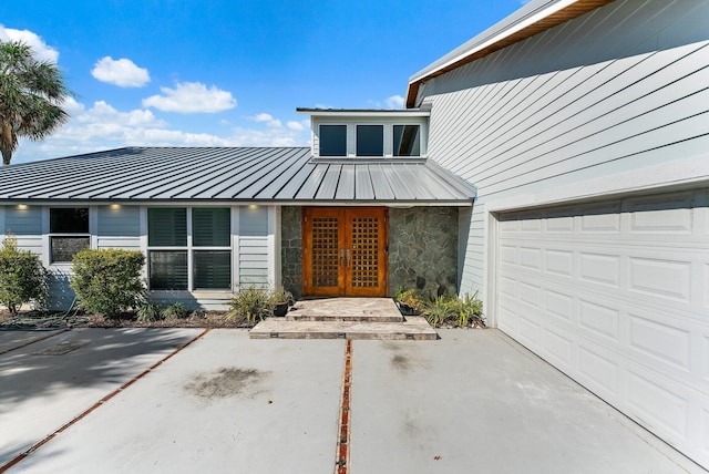 doorway to property featuring a garage and french doors