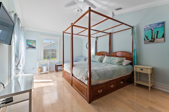 bedroom featuring ornamental molding and light hardwood / wood-style floors