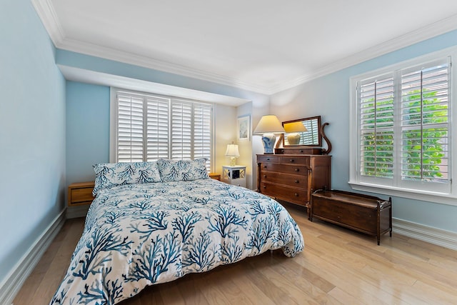 bedroom with light wood-type flooring and ornamental molding