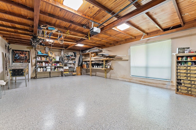 garage with a garage door opener, wood ceiling, and a workshop area