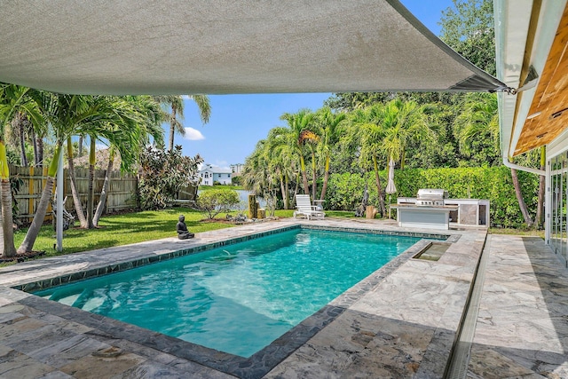 view of swimming pool featuring area for grilling and a patio area