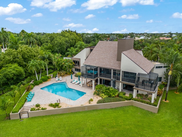 view of swimming pool with a patio and a lawn