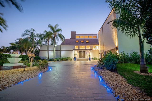 view of outdoor building at dusk