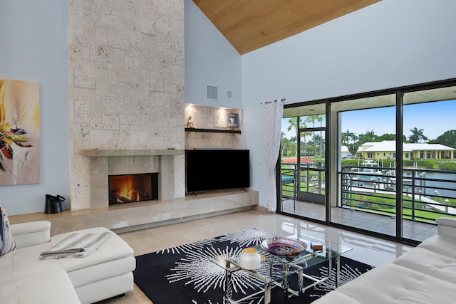 living room featuring high vaulted ceiling, wooden ceiling, and a fireplace