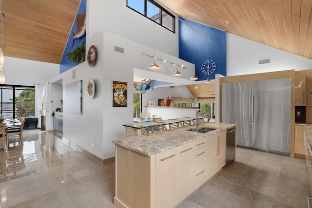 kitchen with a kitchen island with sink, high vaulted ceiling, appliances with stainless steel finishes, and wood ceiling