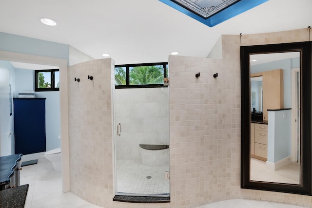 bathroom featuring toilet, a shower with shower door, tile patterned flooring, and plenty of natural light