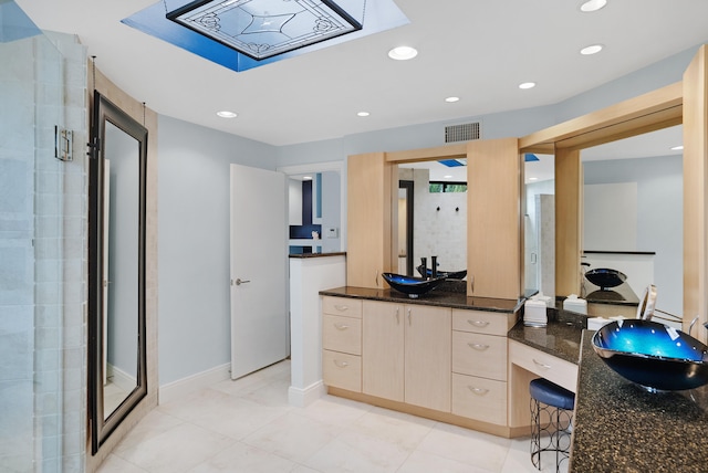 bathroom featuring vanity and a shower with shower door