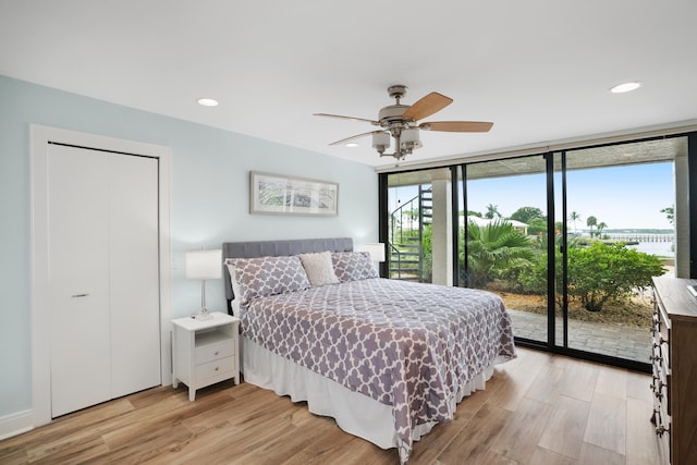 bedroom featuring ceiling fan, a closet, light wood-type flooring, and access to outside