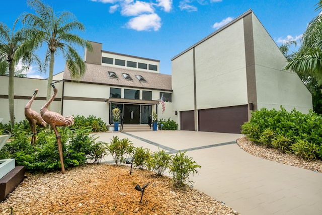 back of property featuring a garage