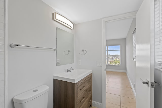 bathroom featuring tile patterned flooring, vanity, and toilet