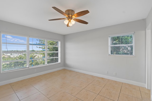 unfurnished room featuring a wealth of natural light, ceiling fan, and light tile patterned floors