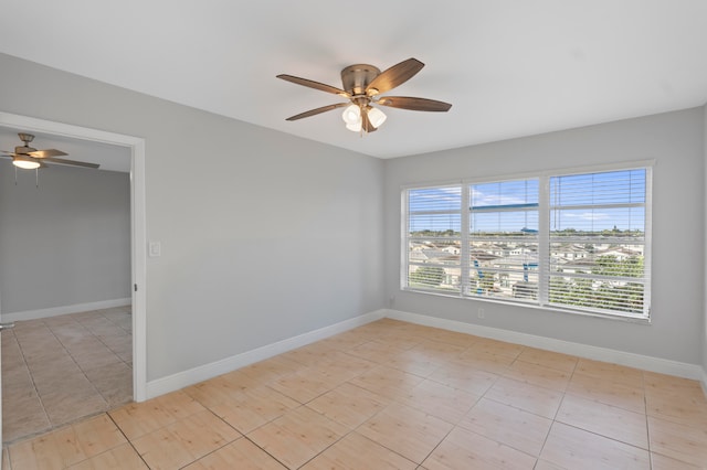 unfurnished room featuring ceiling fan and light tile patterned flooring