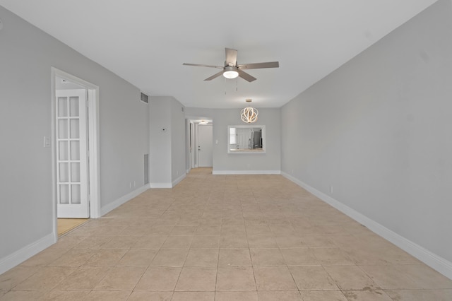 tiled spare room with ceiling fan