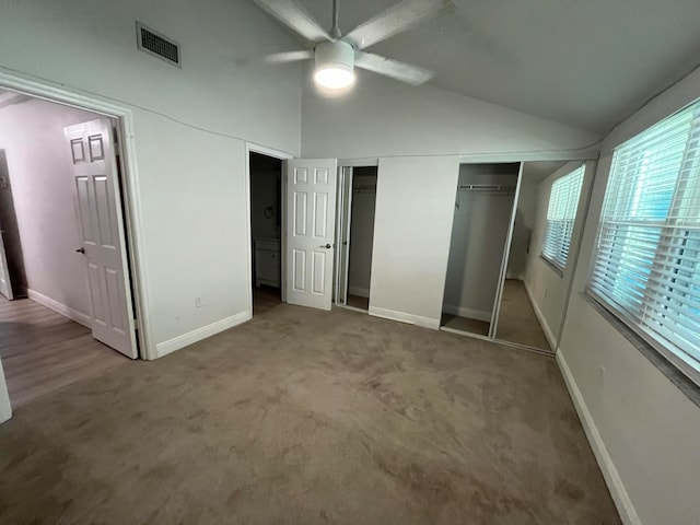 unfurnished bedroom with ceiling fan, a closet, carpet floors, and lofted ceiling