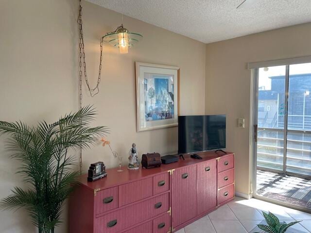 tiled living room featuring a textured ceiling