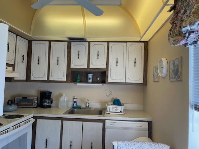 kitchen with white dishwasher, white cabinets, sink, and extractor fan