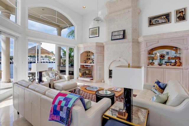 living room with light tile patterned flooring and a towering ceiling