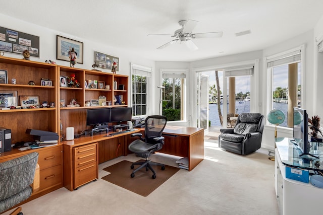 carpeted office featuring ceiling fan