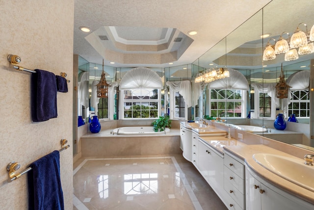 bathroom featuring a tray ceiling, plenty of natural light, and ornamental molding