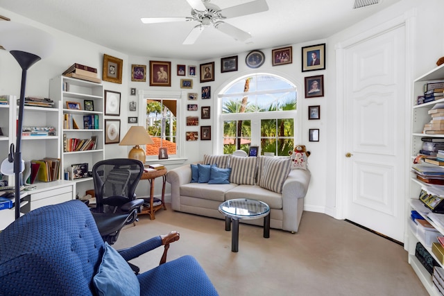 living area featuring ceiling fan and carpet