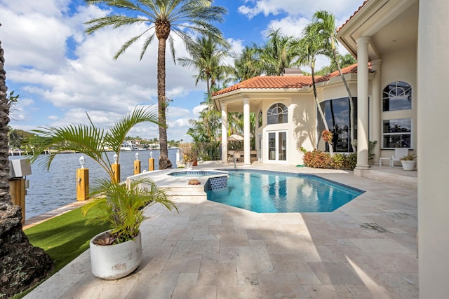 view of pool with a patio area, an in ground hot tub, french doors, and a water view