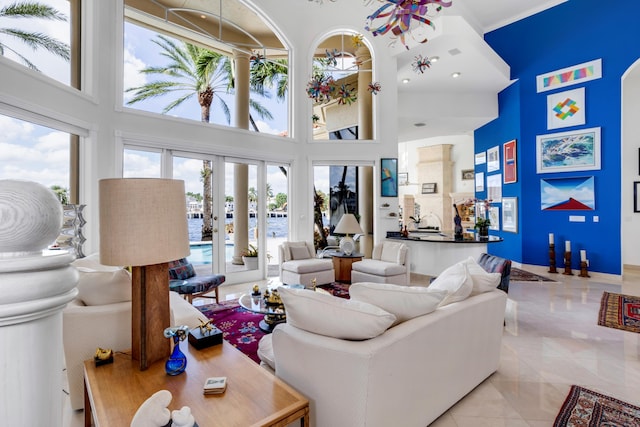 tiled living room featuring a high ceiling and a wealth of natural light