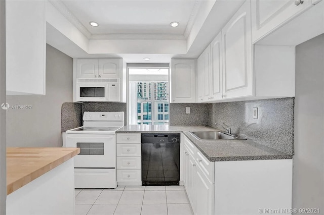 kitchen with white cabinetry, sink, white appliances, and light tile patterned floors