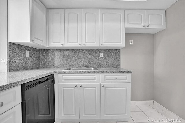 kitchen featuring white cabinets, sink, decorative backsplash, and black dishwasher