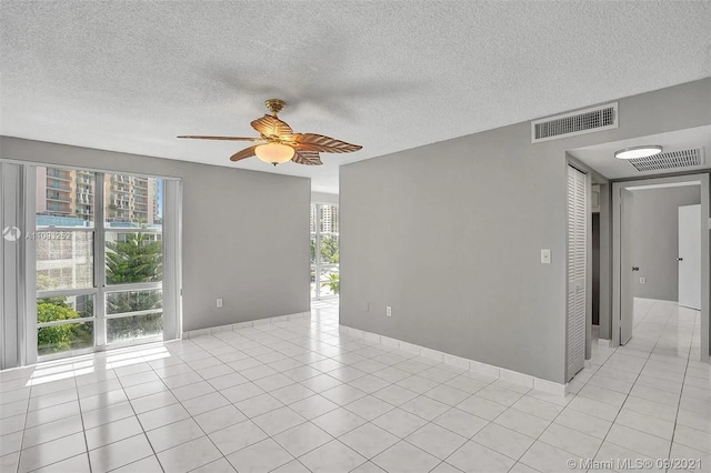 empty room featuring plenty of natural light and a textured ceiling