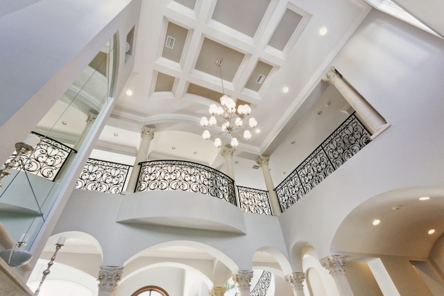 interior details featuring crown molding and a notable chandelier