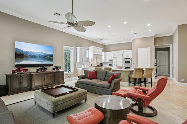 living room with ceiling fan and ornamental molding