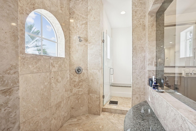 bathroom featuring walk in shower and tile walls