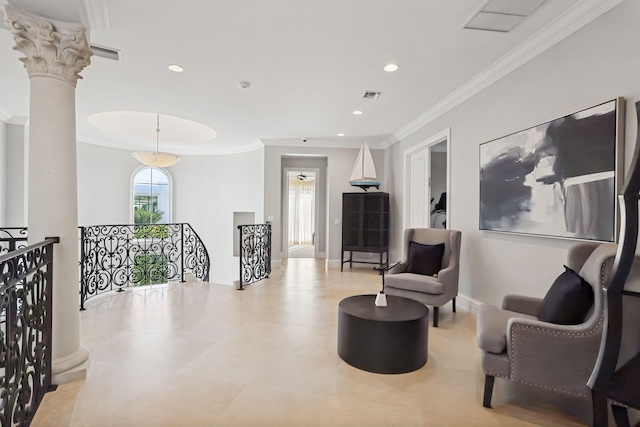 sitting room with ornate columns and crown molding