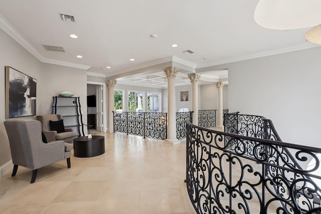 interior space featuring ornate columns and ornamental molding