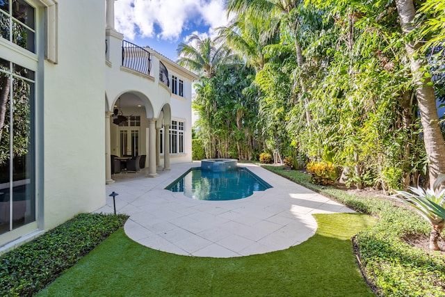 view of swimming pool with an in ground hot tub and a patio