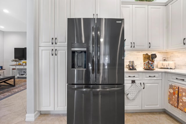 kitchen with tasteful backsplash, stainless steel fridge with ice dispenser, white cabinets, and light tile patterned flooring