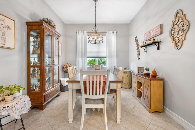 tiled dining room with a notable chandelier