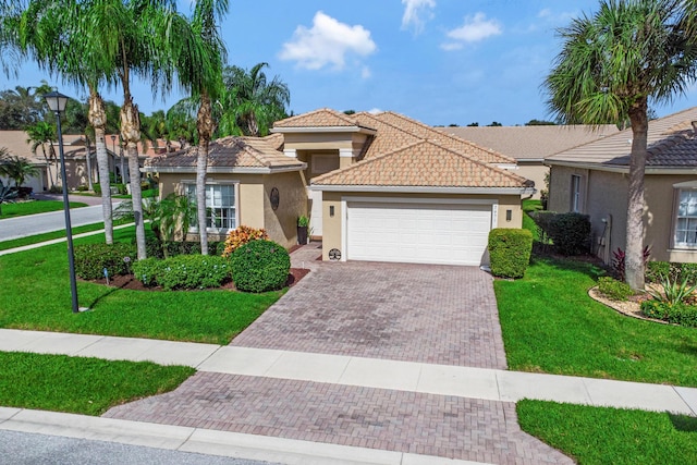 mediterranean / spanish-style home with a garage and a front yard