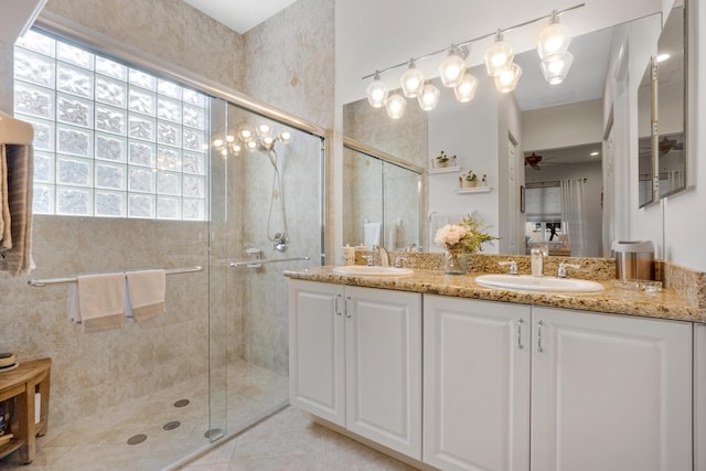 bathroom with tile patterned floors, ceiling fan, a healthy amount of sunlight, and an enclosed shower