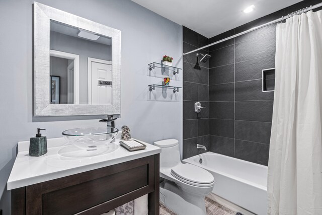 full bathroom featuring vanity, shower / tub combo with curtain, and toilet