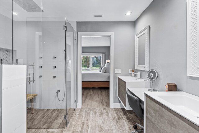 bathroom featuring an enclosed shower and vanity