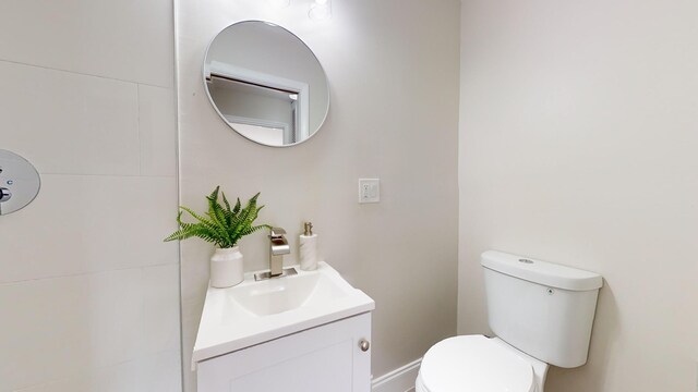 bathroom featuring hardwood / wood-style floors, walk in shower, and vanity